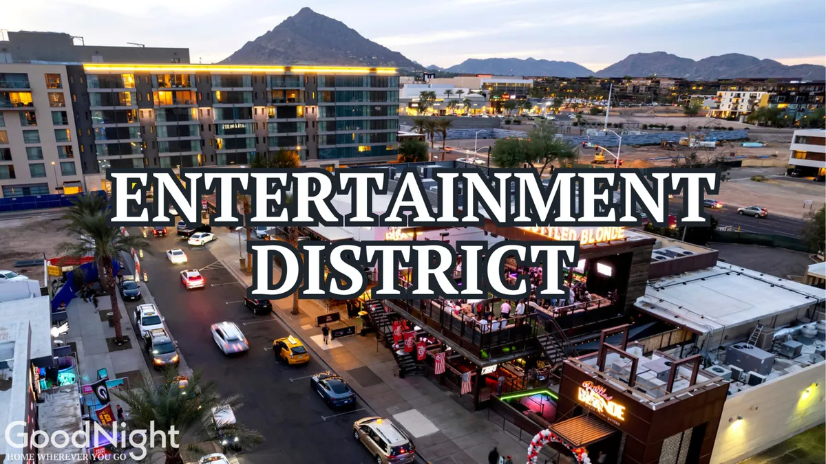 An energetic cityscape with an entertainment venue, cars on a busy street, mountains in the background, and twinkling city lights. The vibrant mood and urban location evoke the excitement of nearby nightlife and local attractions.